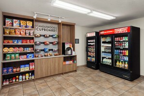 A self-service beverage station with a variety of drinks and snacks. - Candlewood Suites Elgin by IHG (Elgin)