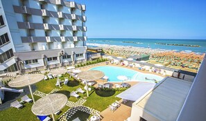 A hotel with a pool area, beach view, and multiple balconies. - Nautilus Family Hotel (Pesaro)