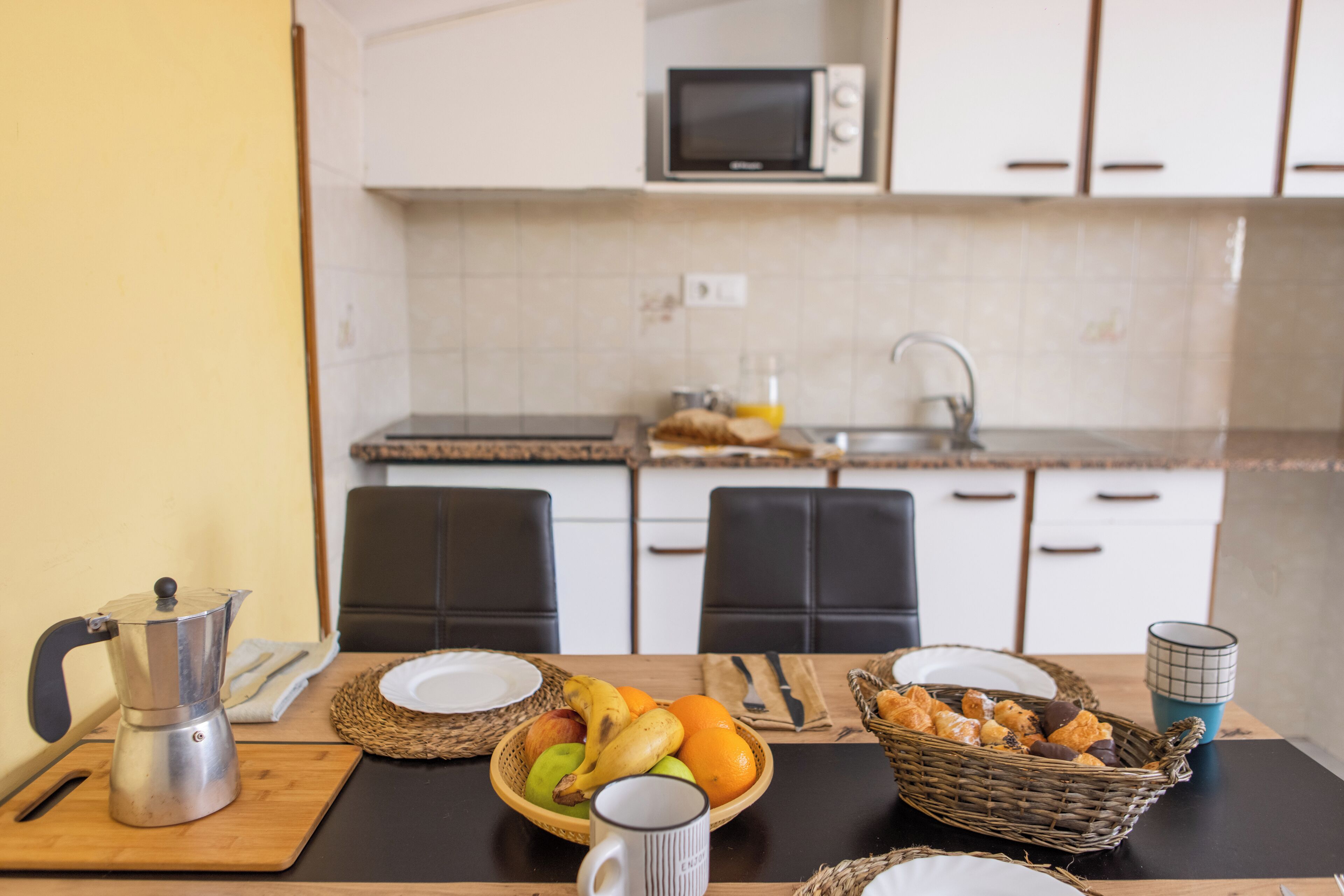 Fridge, microwave, coffee/tea maker, cookware/dishes/utensils
