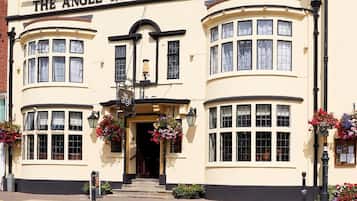 Traditional building with a curved corner entrance and charming details.