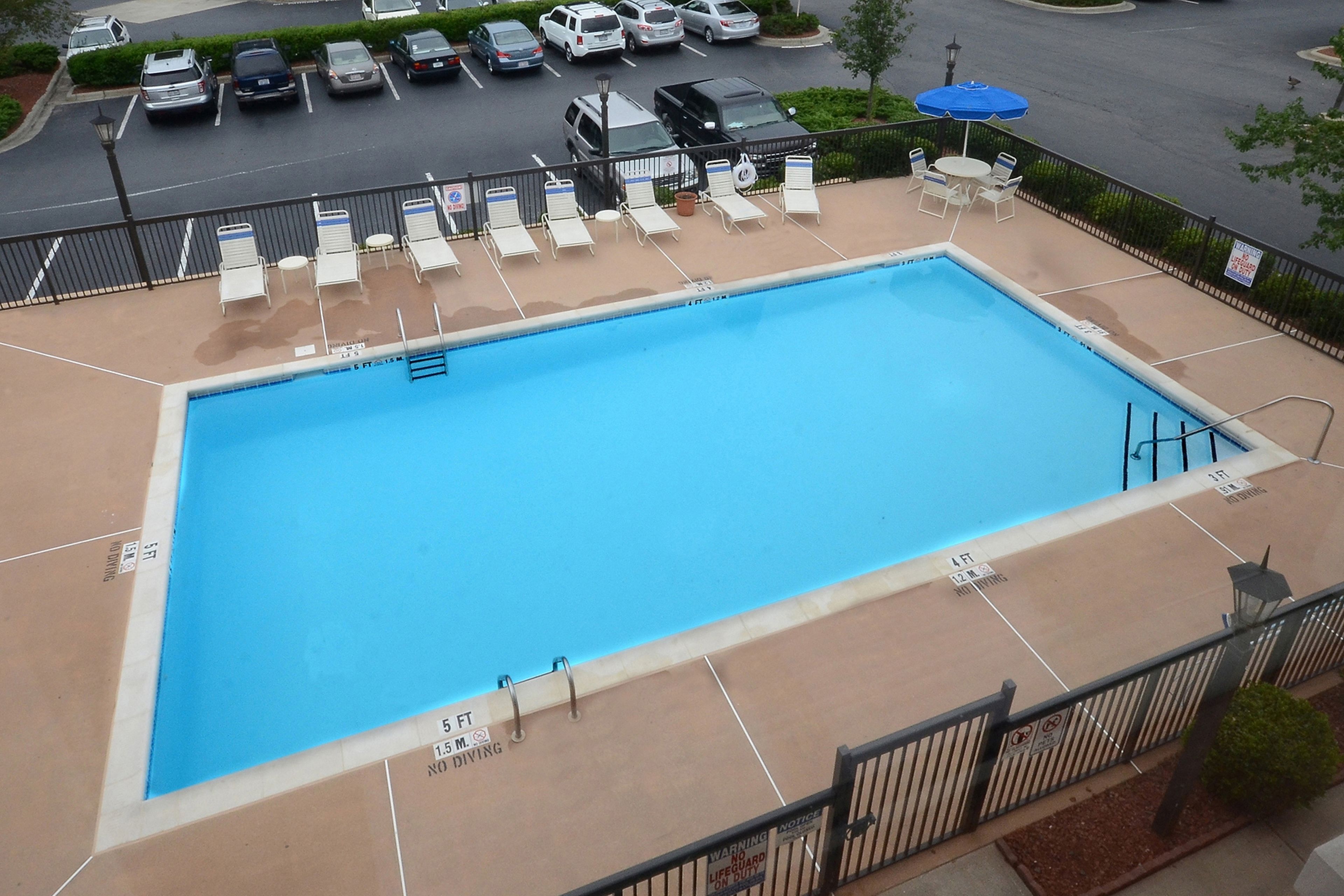seasonal outdoor pool, open 9 am to 10 pm, pool umbrellas, pool loungers