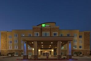 A Holiday Inn Express hotel with a covered entrance, multiple floors, and a brick facade.