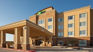 A Holiday Inn Express building with a covered entrance, multiple windows, and a clear sky. - Holiday Inn Express & Suites Austin South-Buda by IHG (Buda)
