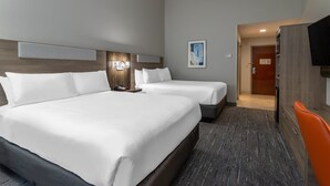 A hotel room with two beds, a wooden headboard, a gray carpet, and a television on the right. - Holiday Inn Express Crystal River by IHG (Crystal River)