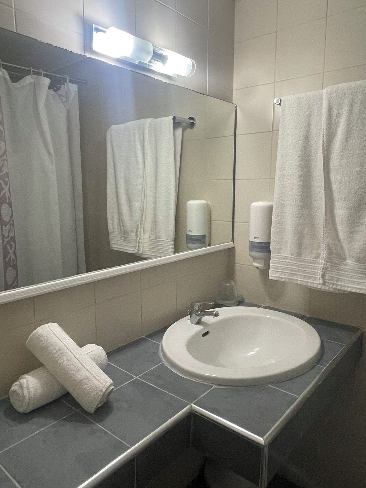 shower, rainfall showerhead, hair dryer, towels