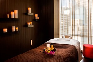 A hotel room with a bed, a red chair, and wall-mounted candles. - theWit Chicago, a Hilton Hotel (Chicago)