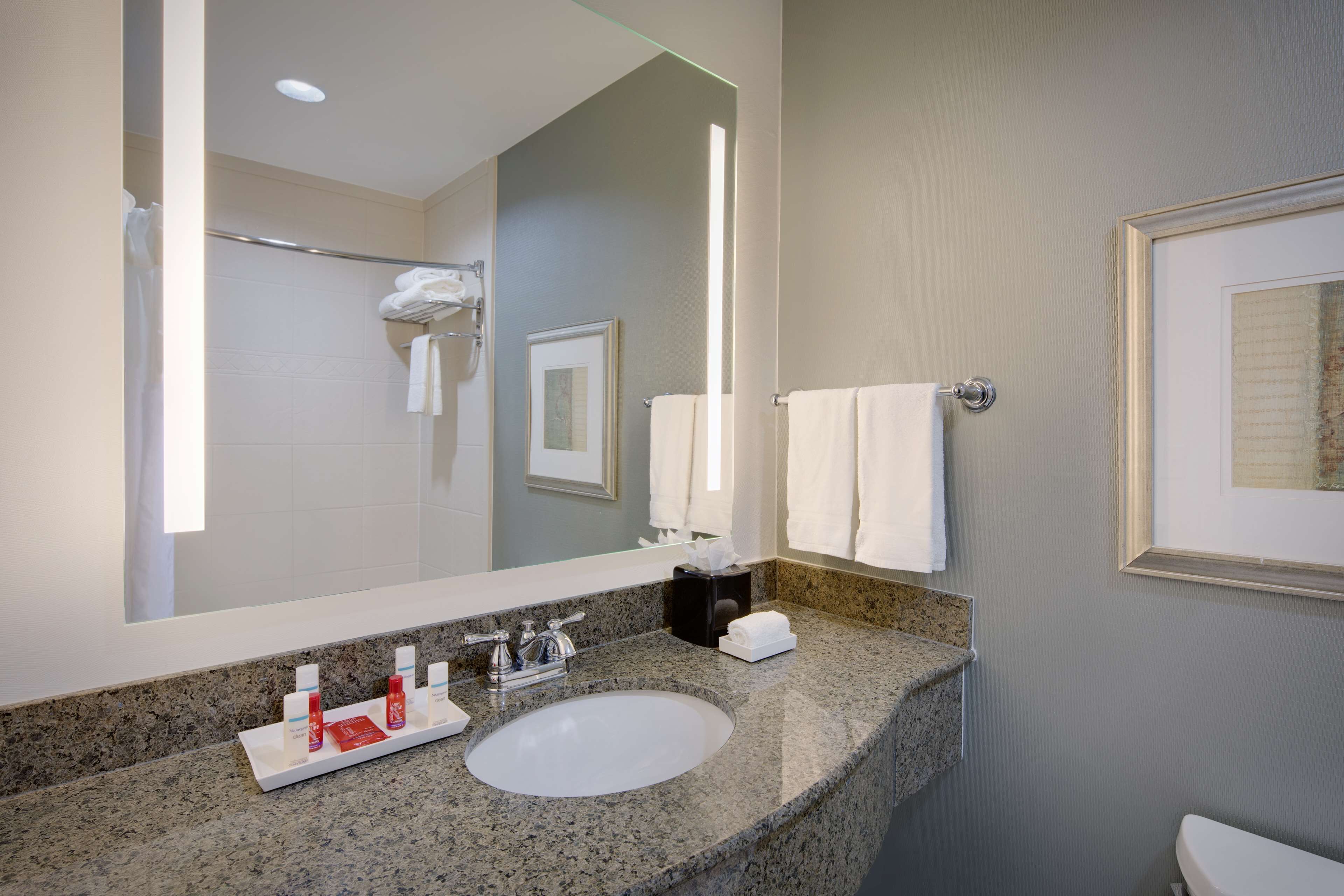 combined shower/bathtub, designer toiletries, hair dryer, towels