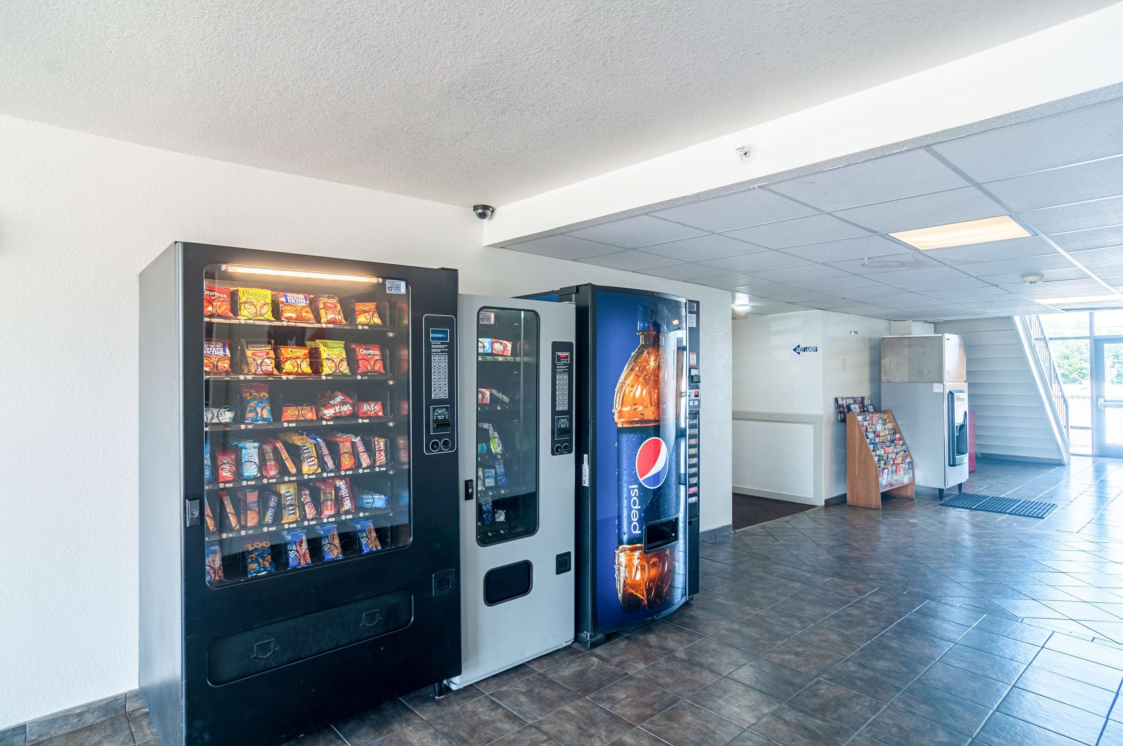 A vending machine area with snack and drink options, a Pepsi advertisement, and a small kiosk.