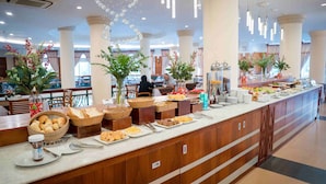 A buffet area with various food items, baskets, and utensils. - Palace Hotel Vung Tau (Ho Chi Minh City)