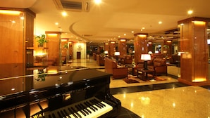 A grand lobby with a grand piano, plush seating, and warm lighting. - Palace Hotel Vung Tau (Ho Chi Minh City)