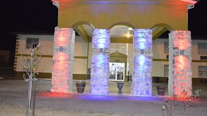 A building with a yellow facade, stone columns, and a sign that reads "Knights Inn." - Knights Inn Greenville, TX (Greenville)