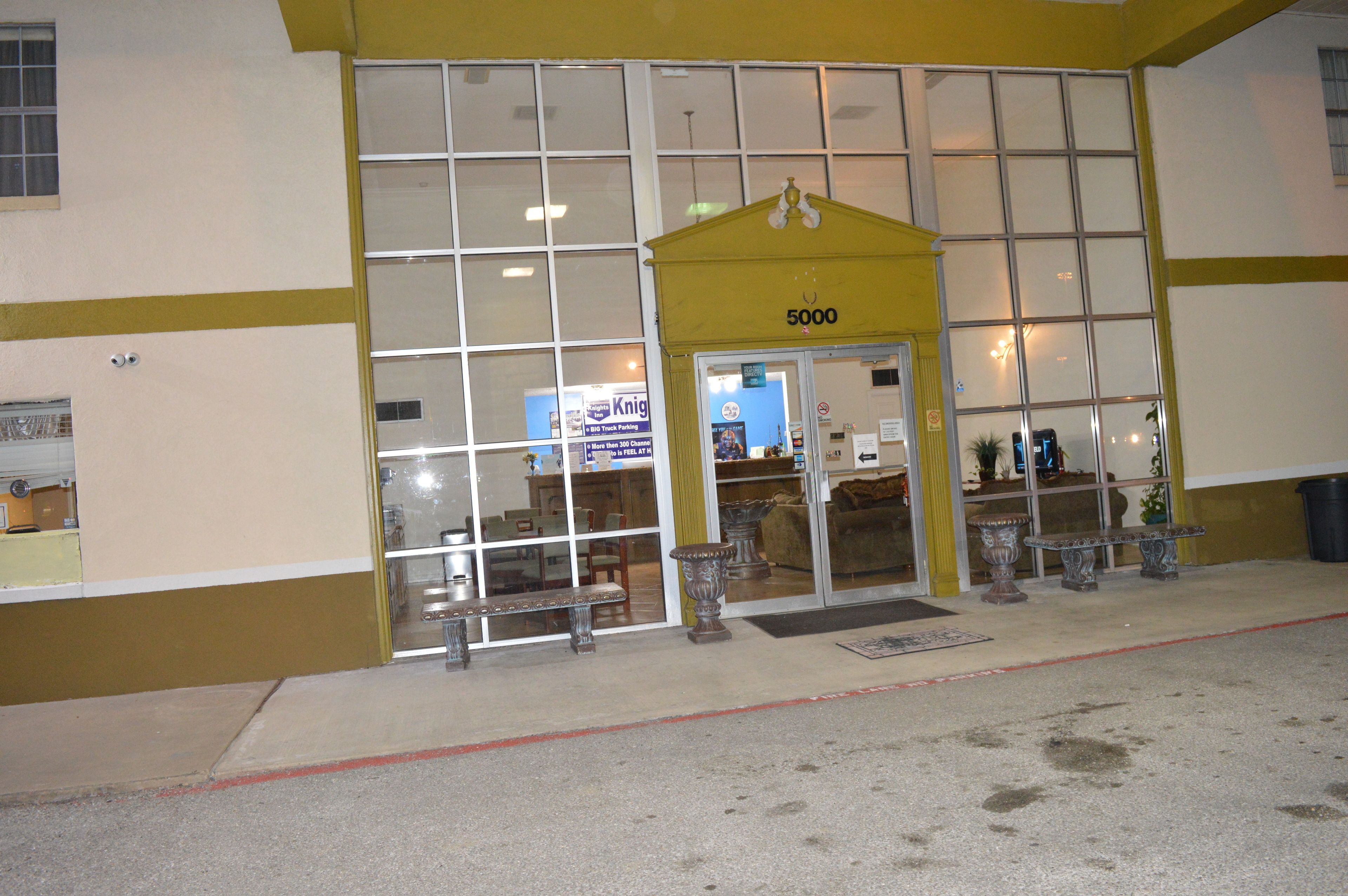 A building with a yellow entrance, large windows, and a number 5000 sign.