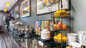 A buffet area with various food items, beverages, and a fruit basket. - Best Western Plus Olathe Hotel (Olathe)