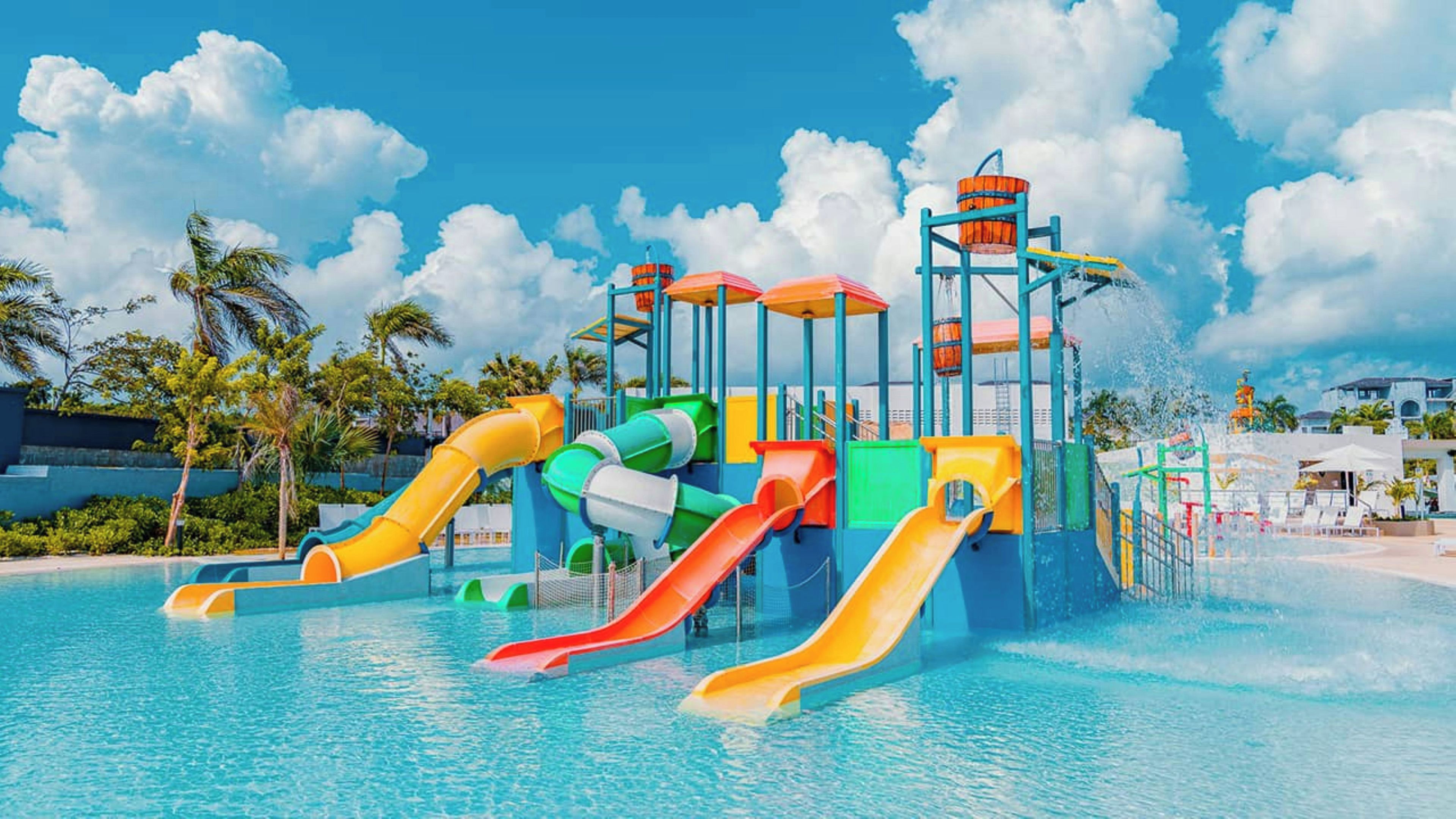 A water park with multiple slides and a pool.