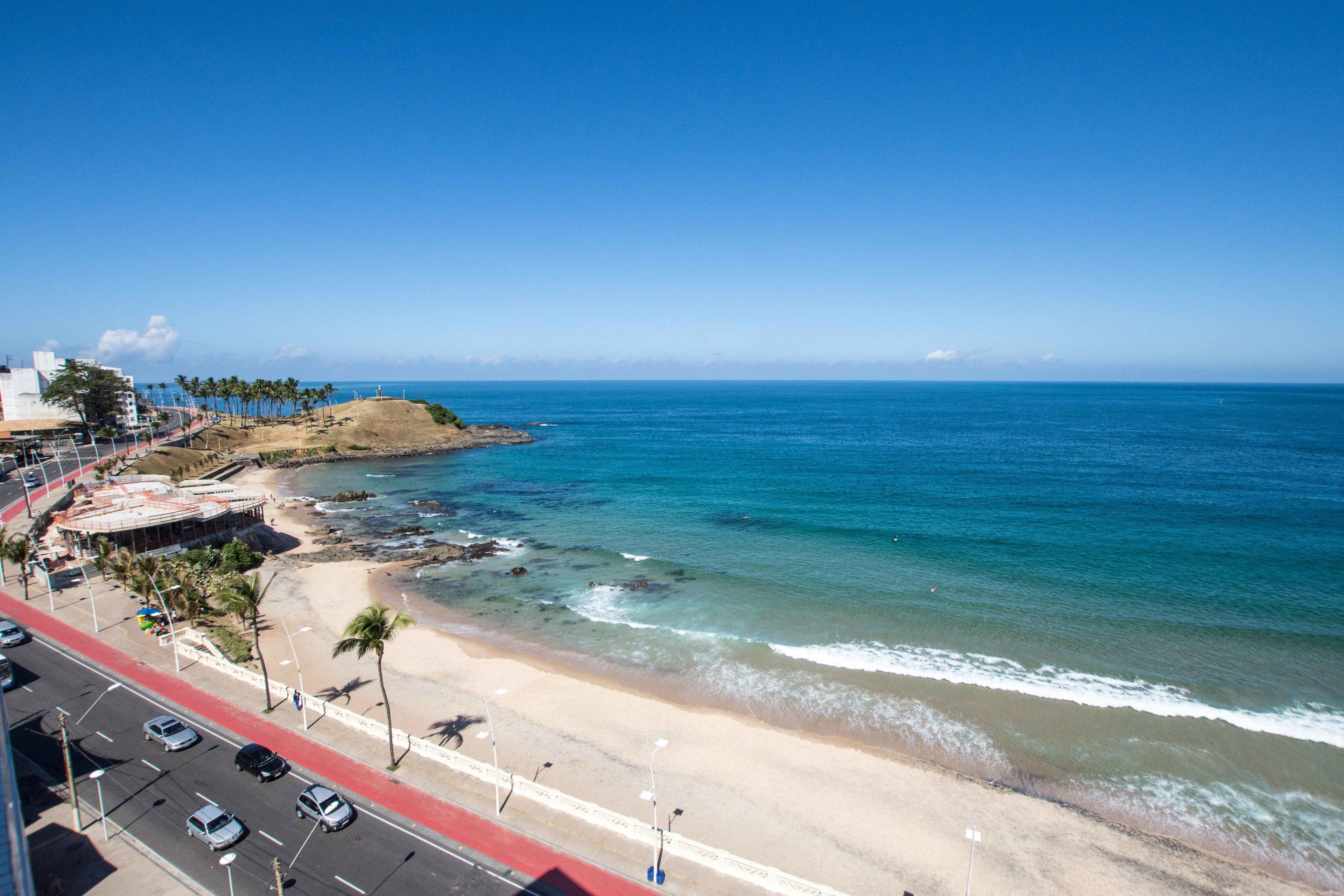 A coastal road with a beach and ocean.