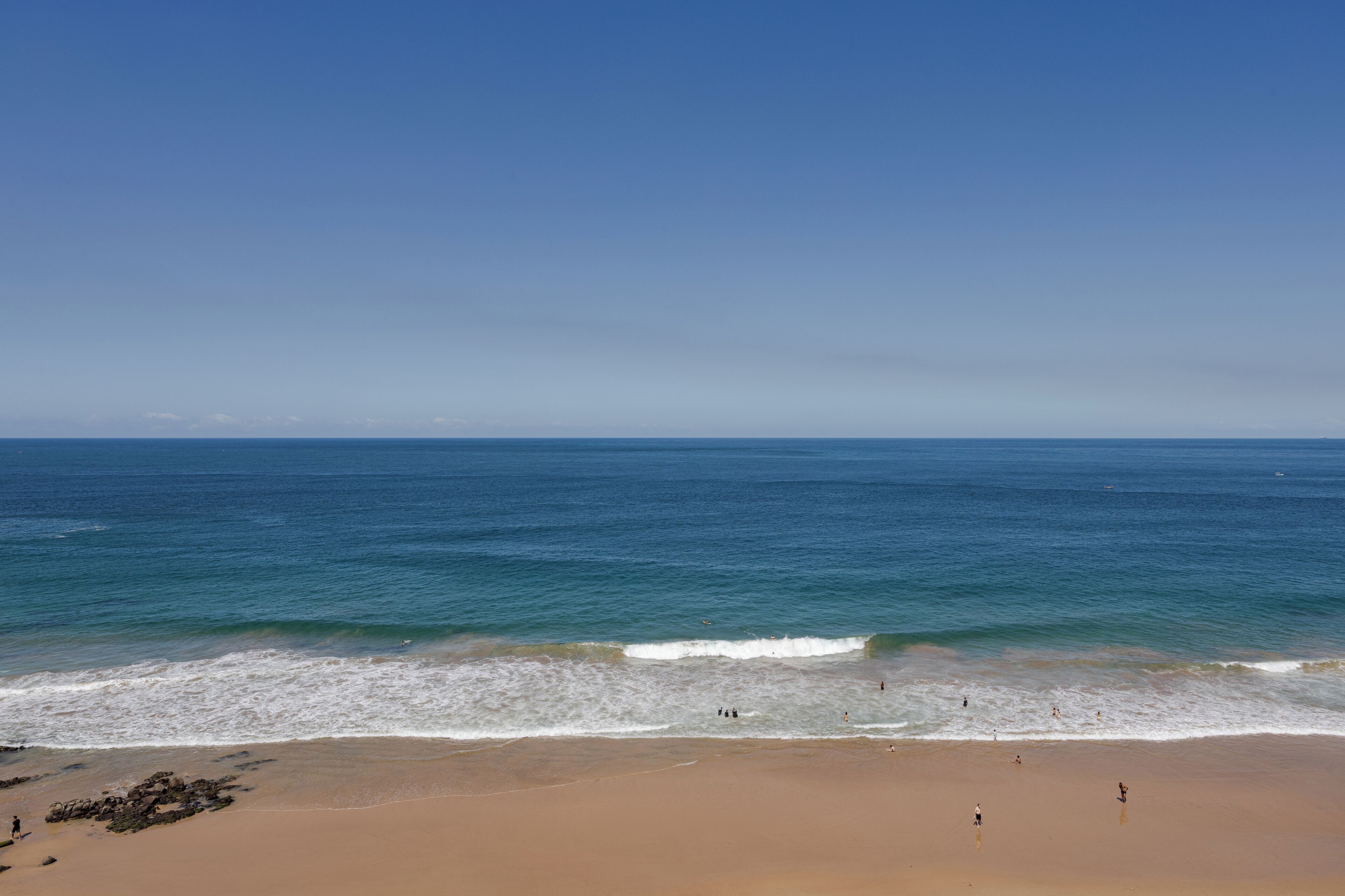 A beach with clear skies and calm waters.