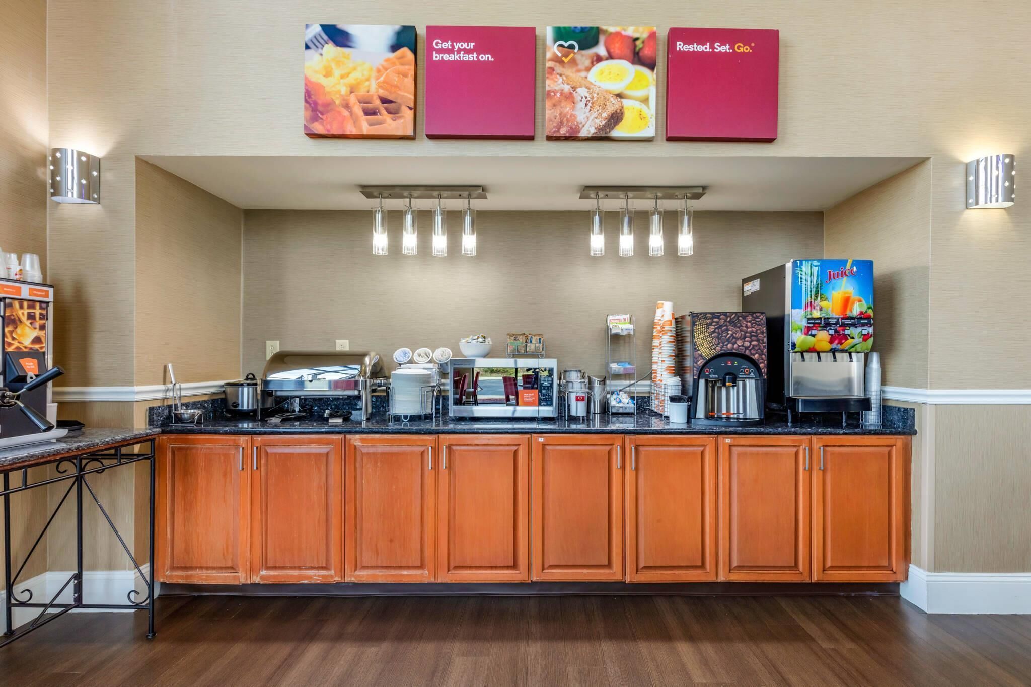 A breakfast bar with a coffee machine, toaster, and various food items.