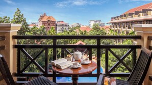 A balcony with a table set for tea, a book, and a teapot. - Angkor Paradise Hotel (Siem Reap)