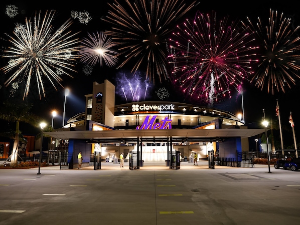 A Clovepark building with a 'Mets' sign, surrounded by fireworks.