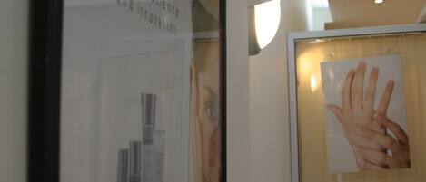 A framed poster of hands on a glass window.