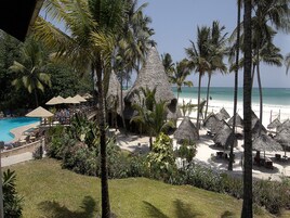 On the beach, white sand, sun loungers, beach umbrellas