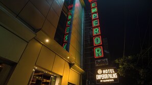 A hotel sign with neon lights spelling "EMPEROR PALMS" and "HOTEL BY ALYASTAYS". - Hotel Emperor Palms at Karol Bagh (New Delhi)