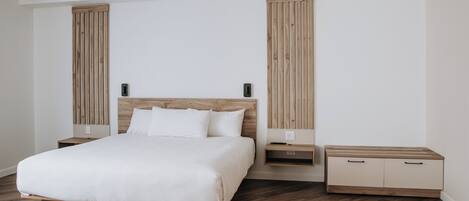 A modern bedroom with a wooden bed, bedside tables, and a built-in wardrobe.