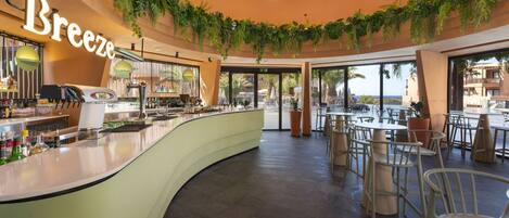 A cafe with a curved counter, a coffee machine, and a sign that reads "Breeze".