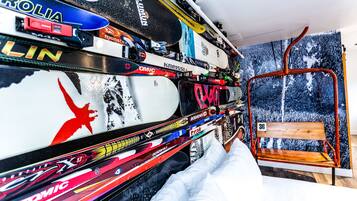 A ski-themed room with a wall decorated with various ski-related stickers and a ski lift chair.