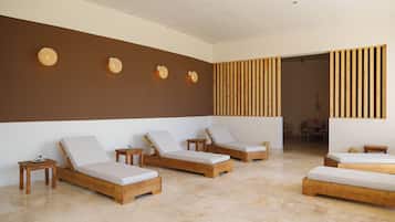 Relax in a serene spa room with a minimalist design, featuring comfortable loungers and a calming atmosphere.