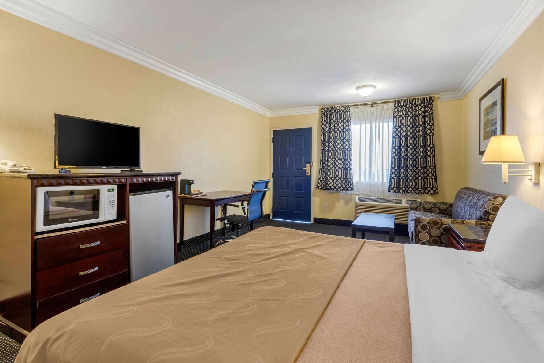 Premium bedding, desk, laptop workspace, blackout curtains