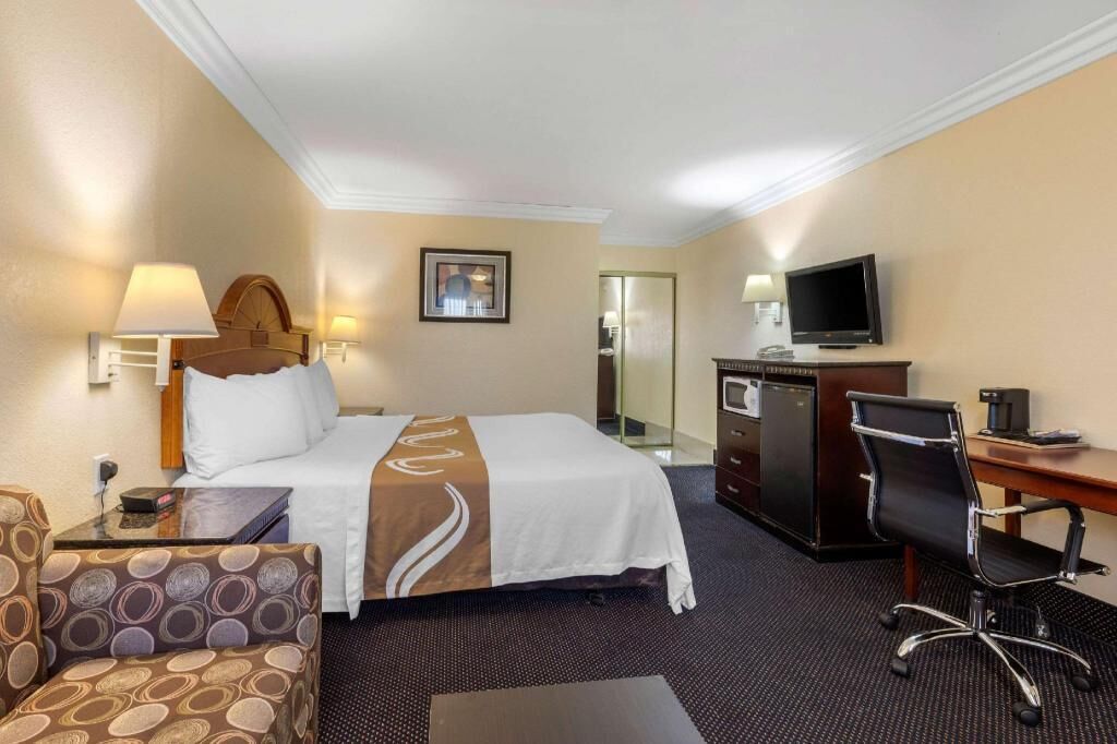 Premium bedding, desk, laptop workspace, blackout curtains