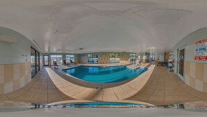A large indoor swimming pool with clear pool rules and hours posted on the walls, surrounded by lounge chairs and a tiled floor. - Comfort Suites Suffolk - Chesapeake (Suffolk)