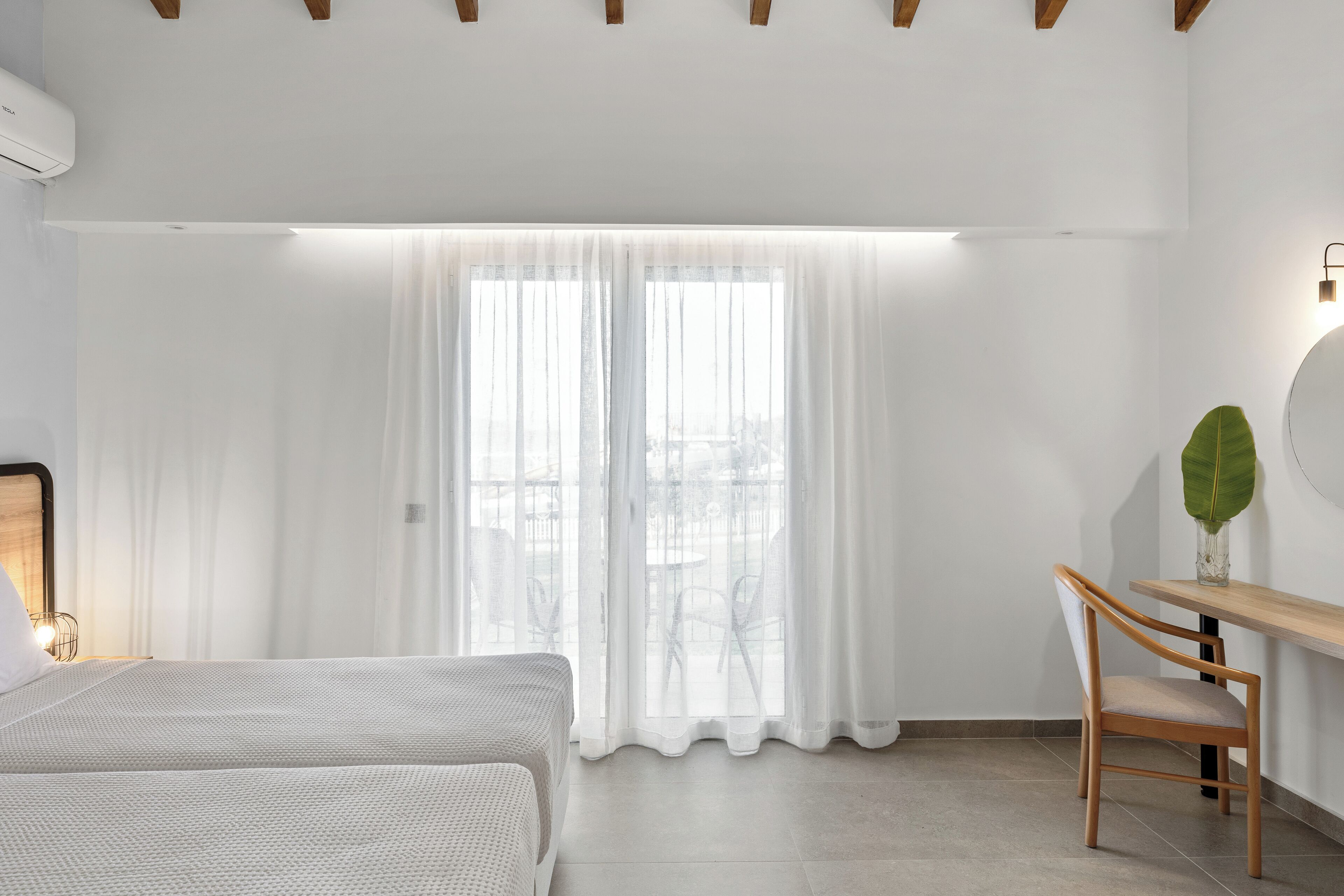 A modern bedroom with a bed, a desk, and a chair.