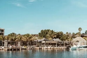 On the beach, white sand, beach cabanas, sun loungers