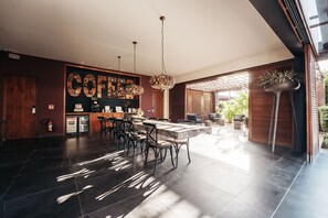 A modern kitchen with a central island, pendant lighting, and a coffee bar.
