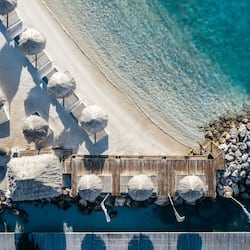 On the beach, white sand, beach cabanas, sun loungers