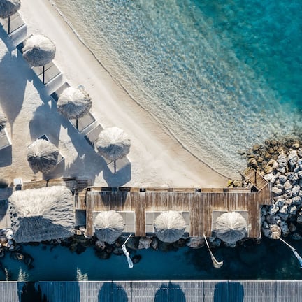 On the beach, white sand, beach cabanas, sun loungers