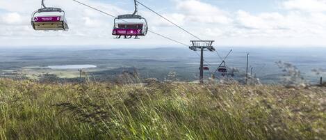 A cable car system with a clear view of the landscape below.