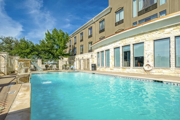 Outdoor pool, open 7 AM to 11:00 PM, pool umbrellas, pool loungers