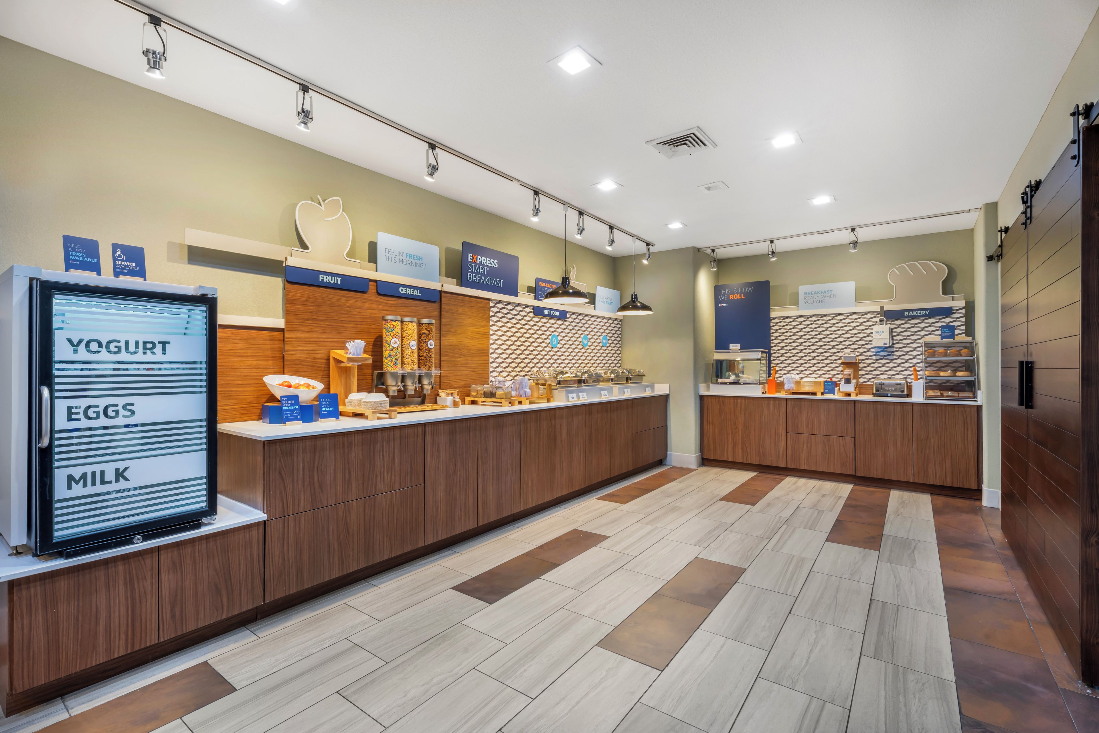 A breakfast area with a self-serve station for yogurt, eggs, and milk.