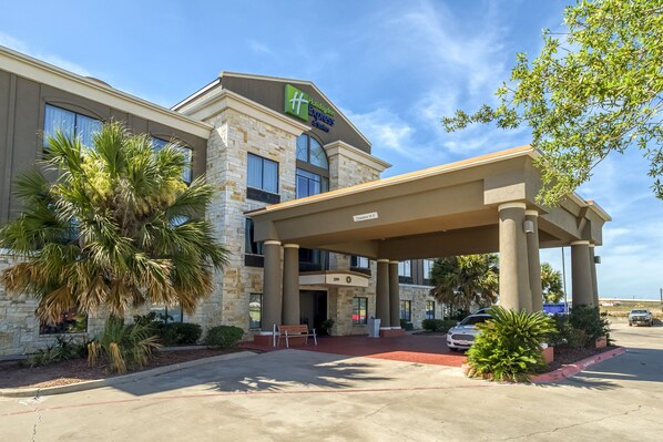 A Holiday Inn Express building with a stone facade, large windows, and a covered entrance area. - Holiday Inn Express Suites Beeville by IHG (Beeville)