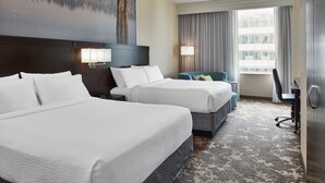 A hotel room with two beds, a desk, a chair, and a large window with curtains. - Courtyard by Marriott Portland City Center (Portland)