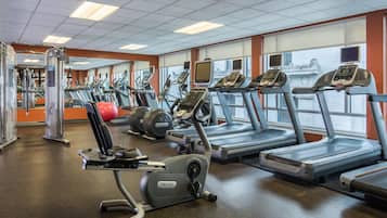 A gym with treadmills, ellipticals, and weight machines.