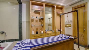A room with a wooden bed, a bathtub, and a large mirror.
