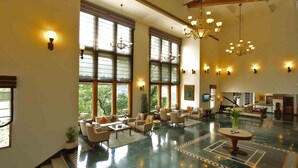 A spacious lobby with a polished marble floor, large windows, and a seating area with multiple chairs and tables. - Jaypee Residency Manor (Dehradun)