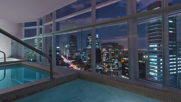 A rooftop pool with a cityscape view.