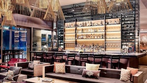 A modern bar area with seating and a wine rack.