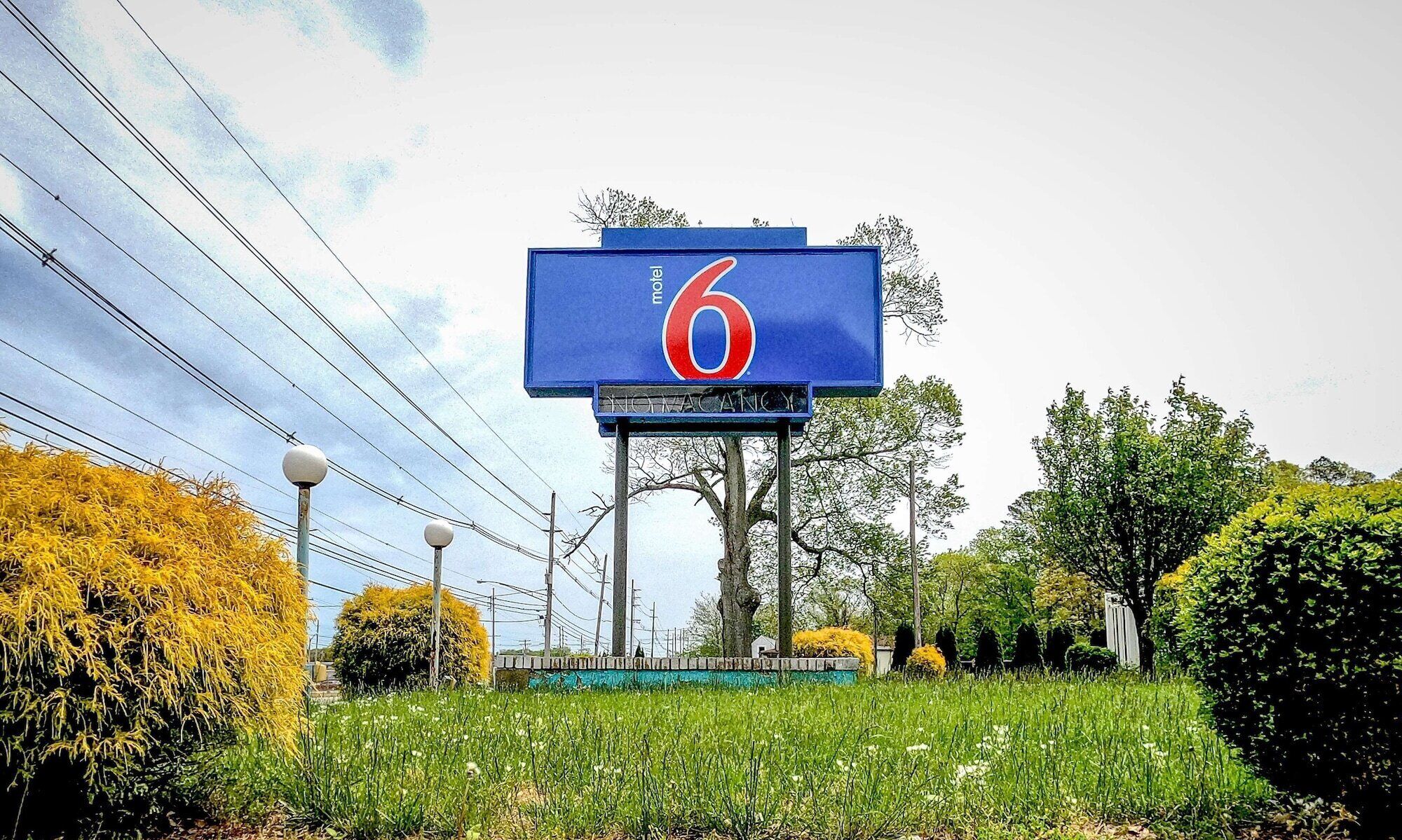 A large blue sign with the number 6, indicating a hotel or motel.