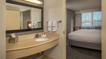 Bañera con ducha, artículos de tocador de diseñador, secador de pelo